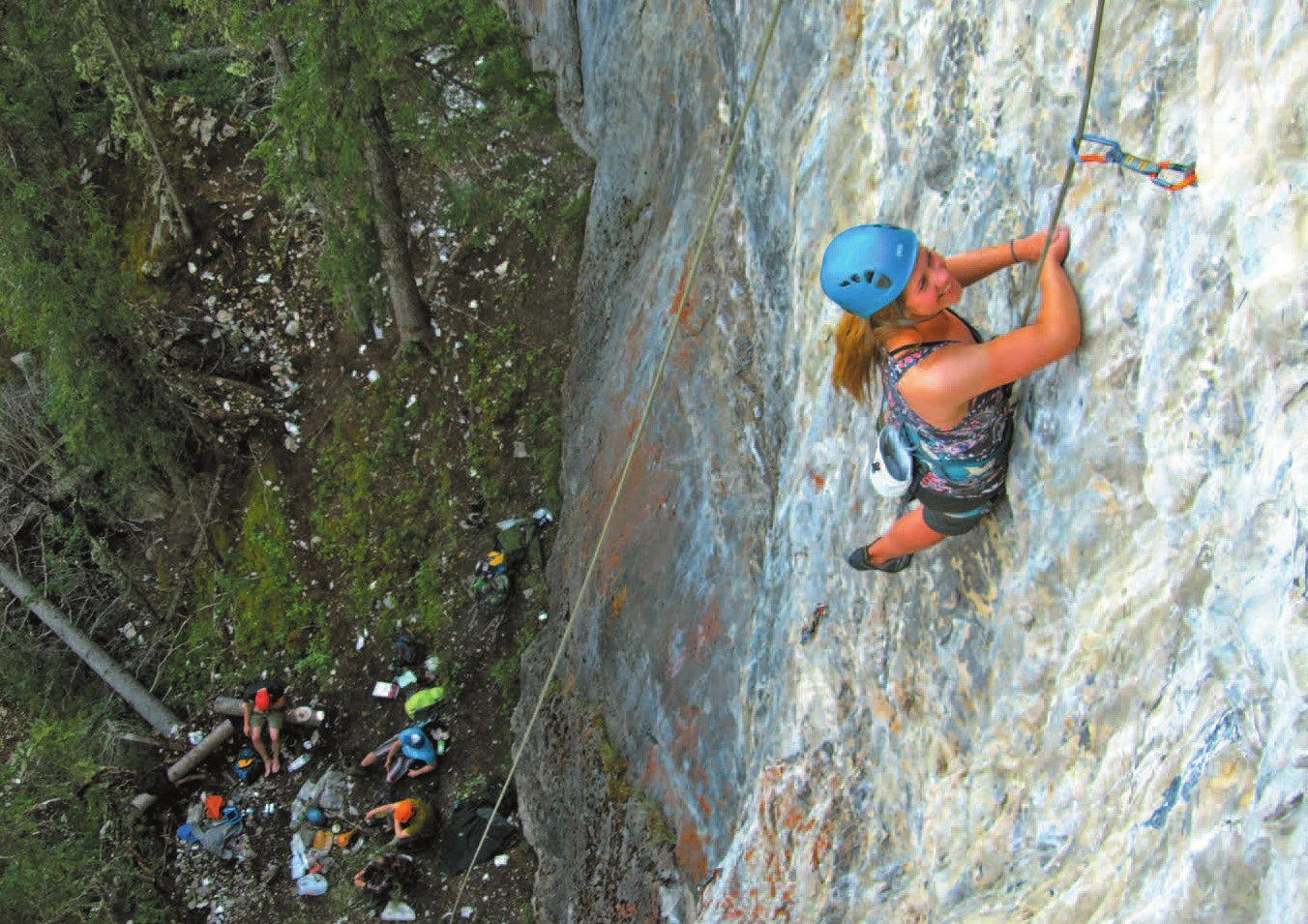 A climber on a top-roped route, photographed from above the anchor