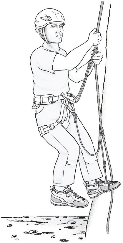 A climber ascending a fixed rope with the lower prusik cord girth hitched around one foot as an etrier (© Petzl)